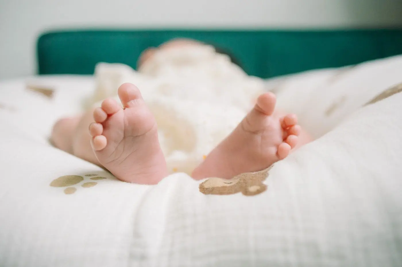 Baby's feet resting on a soft patterned blanket