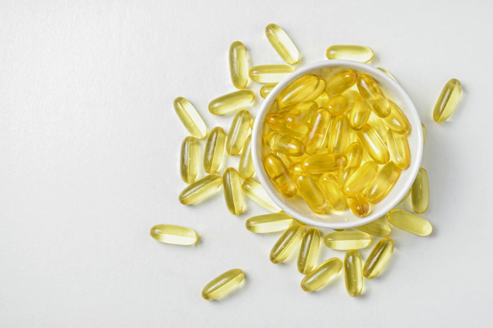 Omega-3 fish oil capsules in a ceramic bowl