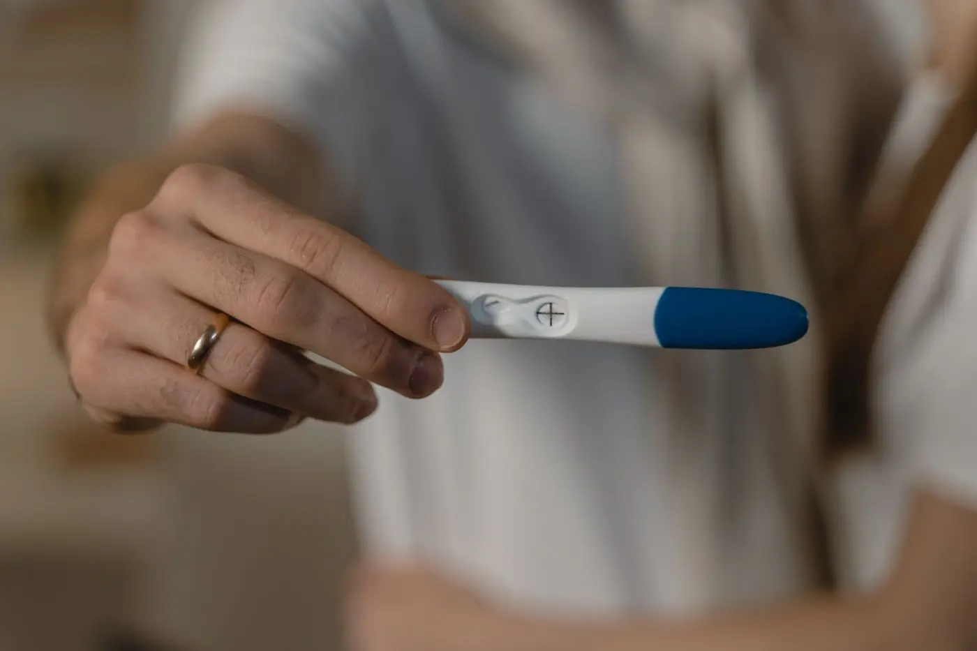 Hand holding a pregnancy test