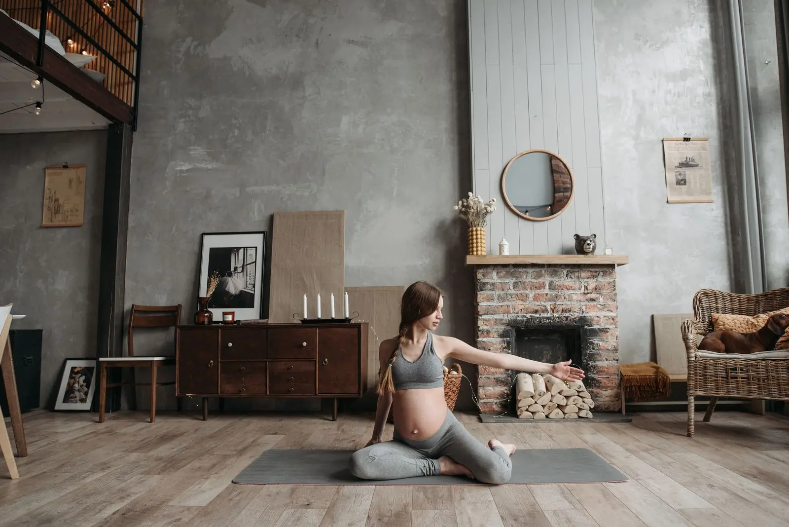 Pregnant woman doing prenatal yoga in her living room