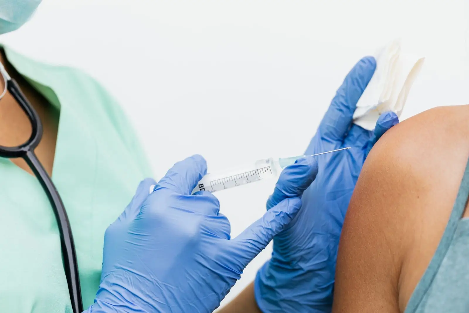 Nurse in gloves giving a vaccine injection