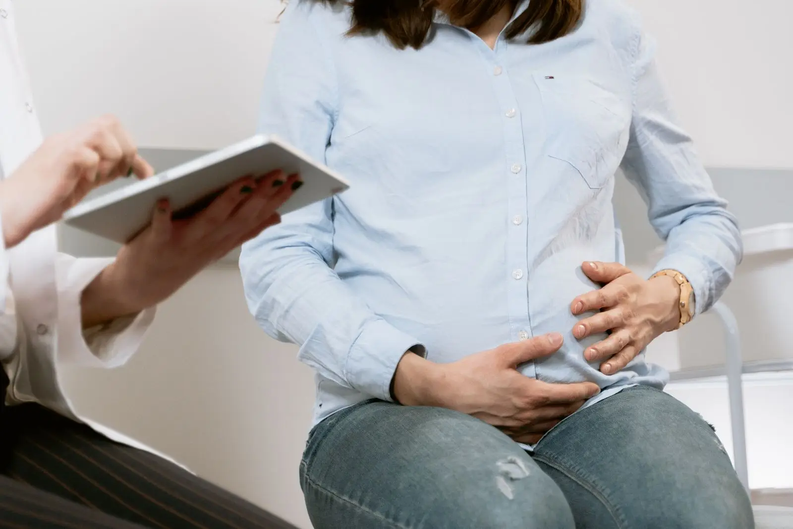 Pregnant woman at a healthcare consultation discussing her baby's position