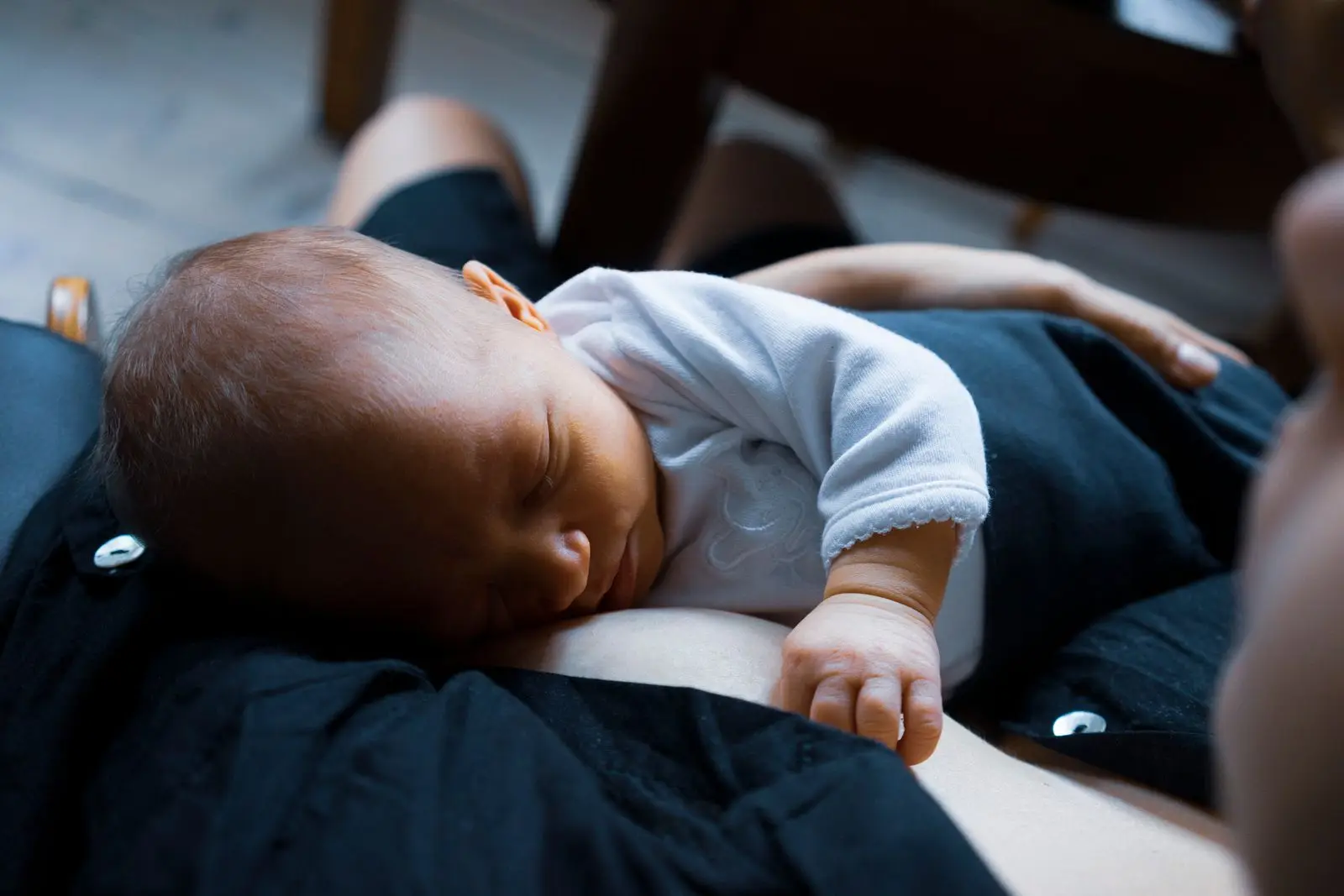 Newborn baby sleeping peacefully on their mother's chest